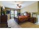 Main bedroom with a large bed, wood furniture, and carpet floors at 5516 Luminar Pointe Ln, Apollo Beach, FL 33572