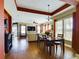 Open concept dining room and living room with hardwood floors at 5516 Luminar Pointe Ln, Apollo Beach, FL 33572