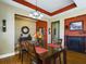 Elegant dining room with a dark wood table and fireplace at 5516 Luminar Pointe Ln, Apollo Beach, FL 33572