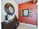 Entryway with a large clock, decorative mirror, and console table at 5516 Luminar Pointe Ln, Apollo Beach, FL 33572