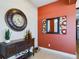 Entryway with a large clock, decorative mirror, and console table at 5516 Luminar Pointe Ln, Apollo Beach, FL 33572