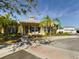 Yellow house with landscaping, palm trees, and driveway at 5516 Luminar Pointe Ln, Apollo Beach, FL 33572