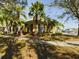 Yellow house with landscaping and palm trees at 5516 Luminar Pointe Ln, Apollo Beach, FL 33572