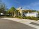 Yellow house with landscaping and palm trees at 5516 Luminar Pointe Ln, Apollo Beach, FL 33572