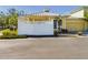 Yellow house with white fence and a metal roof, two-car garage at 5516 Luminar Pointe Ln, Apollo Beach, FL 33572