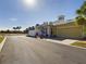 Yellow house with metal roof, white fence, and a two-car garage at 5516 Luminar Pointe Ln, Apollo Beach, FL 33572