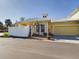 House exterior showcasing yellow siding, metal roof and a two-car garage at 5516 Luminar Pointe Ln, Apollo Beach, FL 33572