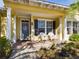 Front porch with gray door, white chairs, and brick flooring at 5516 Luminar Pointe Ln, Apollo Beach, FL 33572