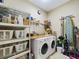 Laundry room with washer, dryer, shelving, and storage at 5516 Luminar Pointe Ln, Apollo Beach, FL 33572