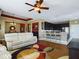 Open living room and kitchen with hardwood floors, and a breakfast bar at 5516 Luminar Pointe Ln, Apollo Beach, FL 33572