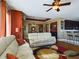 Open living room and kitchen with hardwood floors, and a breakfast bar at 5516 Luminar Pointe Ln, Apollo Beach, FL 33572