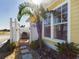 Small patio with table and chairs, adjacent to a yellow house at 5516 Luminar Pointe Ln, Apollo Beach, FL 33572