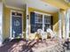 Front porch with white chairs and a gray door at 5516 Luminar Pointe Ln, Apollo Beach, FL 33572