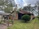 Backyard view of a ranch home with a swing at 1005 S Empire St, Plant City, FL 33563