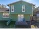 Home's rear elevation showcasing a patio and fenced yard at 1008 Highgrove Ct, Valrico, FL 33596