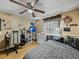 Bright bedroom with a double bed, dresser, and gaming setup at 1008 Highgrove Ct, Valrico, FL 33596