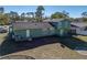 Green house back with large backyard and trampoline at 1008 Highgrove Ct, Valrico, FL 33596