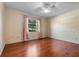 Empty bedroom with hardwood floors and floral wallpaper at 1813 Laurel Oak Dr, Valrico, FL 33596