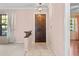 Interior view of an entryway with a wooden door and light pink walls at 1813 Laurel Oak Dr, Valrico, FL 33596