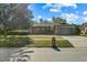 Brick house with a green garage door and well-maintained lawn at 1813 Laurel Oak Dr, Valrico, FL 33596