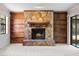 Stone fireplace with wood mantel and built-in shelves at 1813 Laurel Oak Dr, Valrico, FL 33596