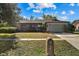 Front view of a brick ranch house with a two-car garage and a mailbox at 1813 Laurel Oak Dr, Valrico, FL 33596