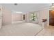 Spacious living room with light pink walls and neutral carpeting at 1813 Laurel Oak Dr, Valrico, FL 33596