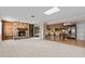 Open living area with a stone fireplace and kitchen at 1813 Laurel Oak Dr, Valrico, FL 33596