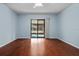 Main bedroom with hardwood floors and sliding doors to porch at 1813 Laurel Oak Dr, Valrico, FL 33596