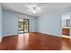 Main bedroom with hardwood floors and sliding doors to porch at 1813 Laurel Oak Dr, Valrico, FL 33596