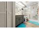 Bathroom with gray vanity, walk-in shower, and accessible toilet at 3055 Casa Del Sol Cir # 208, Clearwater, FL 33761