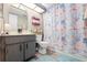 Clean bathroom with gray vanity, shower, and starfish-themed curtain at 3055 Casa Del Sol Cir # 208, Clearwater, FL 33761