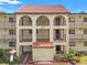 Spanish style condo building with red tile roofs and balconies at 3055 Casa Del Sol Cir # 208, Clearwater, FL 33761