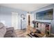 Spacious living area with TV, comfortable couch, and rustic-style cabinet at 3055 Casa Del Sol Cir # 208, Clearwater, FL 33761