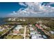Aerial view of house on canal with neighborhood and golf course visible at 10436 Raymond St, Englewood, FL 34224