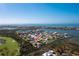 Aerial view showcasing waterfront property with canal access and golf course nearby at 10436 Raymond St, Englewood, FL 34224