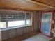 Unfinished basement room with new window and door installation at 10436 Raymond St, Englewood, FL 34224