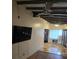 Living room with hardwood floors, exposed beams and a large TV at 2700 9Th N Ave, St Petersburg, FL 33713