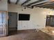 Living room with hardwood floors, exposed beams, and a view of kitchen at 2700 9Th N Ave, St Petersburg, FL 33713