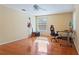 Bedroom with hardwood floors, neutral paint, multiple windows, and a ceiling fan at 5808 Falconcreek Pl, Lithia, FL 33547