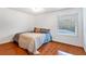 Bedroom featuring hardwood floors, neutral paint, a window with a view, and a ceiling fan at 5808 Falconcreek Pl, Lithia, FL 33547