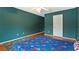 Bedroom with hardwood floors, ceiling fan, and dark green colored walls at 5808 Falconcreek Pl, Lithia, FL 33547