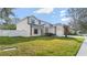 Two-story home with a well-manicured lawn and neutral paint at 5808 Falconcreek Pl, Lithia, FL 33547