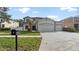 Lovely home featuring a three car garage and freshly-mowed lawn at 5808 Falconcreek Pl, Lithia, FL 33547
