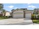 Lovely home featuring a three car garage and driveway at 5808 Falconcreek Pl, Lithia, FL 33547