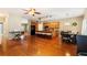 Spacious kitchen featuring a large island with breakfast bar, dining table, and wood floors at 5808 Falconcreek Pl, Lithia, FL 33547