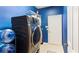 Convenient laundry room features a modern washer/dryer, shelving, and plenty of room for sorting and folding at 5808 Falconcreek Pl, Lithia, FL 33547