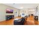 Cozy living room with hardwood floors, natural light, and comfortable furnishings at 5808 Falconcreek Pl, Lithia, FL 33547