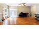 Open room with hardwood floors and natural light from the patio doors at 5808 Falconcreek Pl, Lithia, FL 33547
