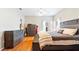 Comfortable main bedroom showcases hardwood floors, neutral paint, windows for natural light, and stylish furnishings at 5808 Falconcreek Pl, Lithia, FL 33547